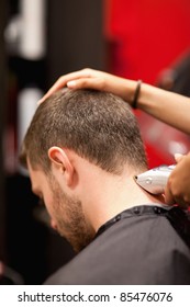 Portrait Of A Male Young Student Having A Haircut With A Hair Clippers