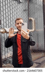 
Portrait Of A Man 20-30 Years Old Looking At The Phone On The Street, Video Chat, Selfie