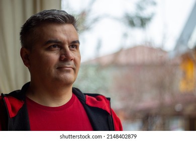 Portrait Of A Man 40-50 Years Old, Gray-haired, Swarthy. Looking Away. Big Eyebrows. Red Jacket.