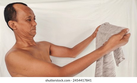 portrait the man Acting like he smells bad of dirty clothes, musty smell, stink,  health care and medical concept.