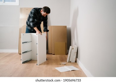 Portrait Of Man Assembling Furniture. Do It Yourself Furniture Assembly.