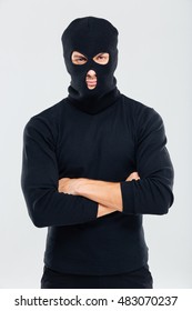 Portrait Of Man In Balaclava Standing With Arms Crossed