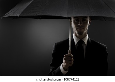 Portrait  Man The  Beautiful  Man In Black Costume With Blak Umbrella,  Special-service Agent Or  Body Guard