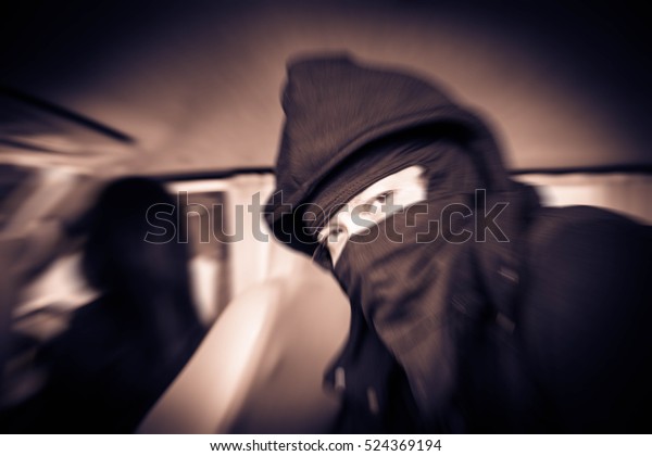 Portrait\
man in black mask and woman in the car,Dangerous man ,Fear ,Murder,\
hijack,rape and crime concept,Sepia,Motion\
blur