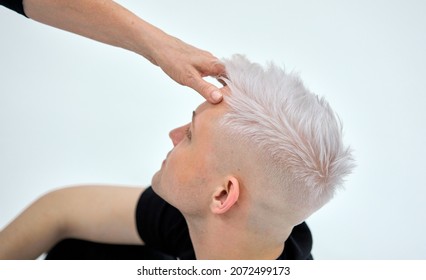 Portrait Of A Man With Blond Hair On A White Background