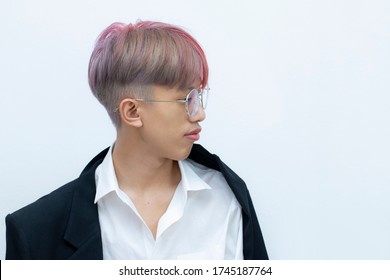 Portrait Of A Man With Bright Colored Flying Hair, All Shades Of Red,purple. Hair Coloring.Hair Fluttering In The Wind. Teen Age With Short Hair. Professional Coloring.