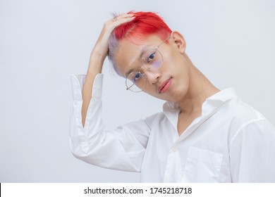 Portrait Of A Man With Bright Colored Flying Hair, All Shades Of Red,purple. Hair Coloring.Hair Fluttering In The Wind. Teen Age With Short Hair. Professional Coloring.