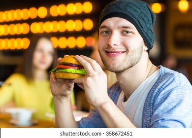 
Portrait Of A Man With A Burger In His Hand