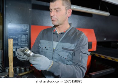 portrait of man checking a bolt