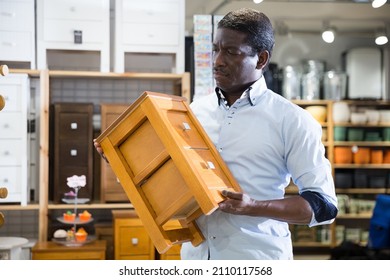 Portrait Of Man Choosing Dressing Table In Furniture Store