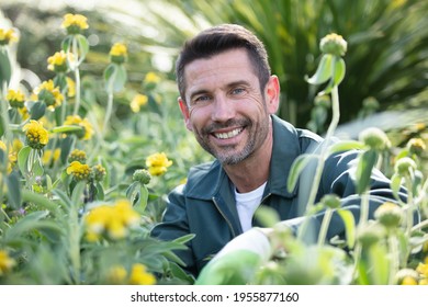 Portrait Of A Man Choosing Plants At Garden Center