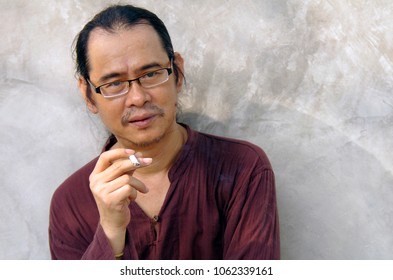 portrait of man with cigarettes