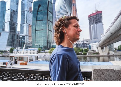 Portrait of man in the city on the background of large buildings complex Moscow-city, skyscrapers in the center of Moscow, Russia. - Shutterstock ID 2007949286