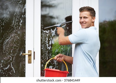 Portrait Of Man Cleaning House Windows