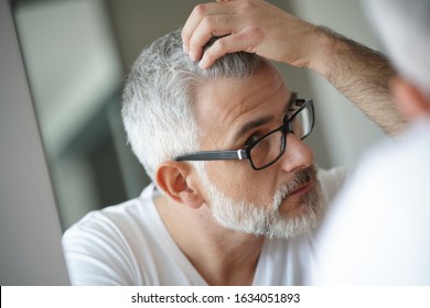 Portrait Of Man Concerned By Hair Loss