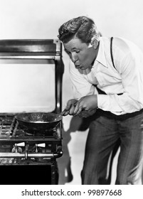 Portrait Of Man Cooking On Stove