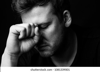 Portrait of a man in depression on a black background