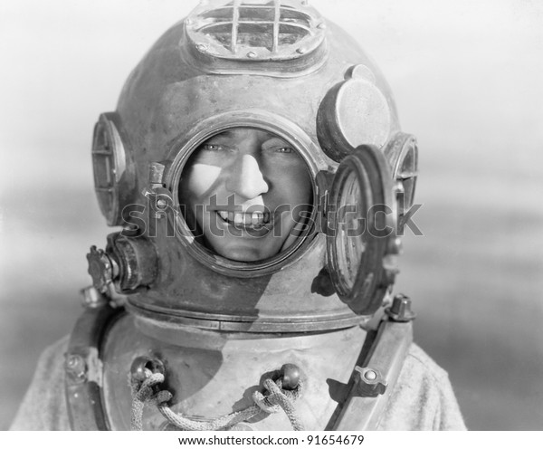 Portrait of man in diving\
helmet
