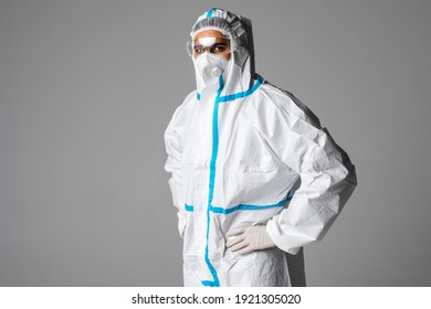 Portrait Of Man Doctor Wearing Googles, Protective Glasses In Protection Suit, Face Surgical Mask On White Background.