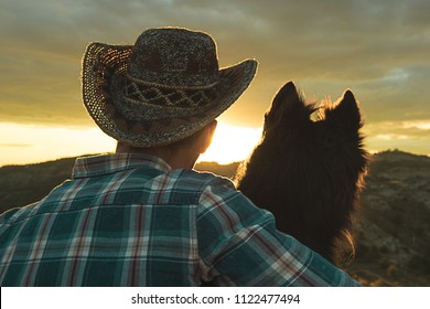 Portrait Of A Man And A Dog In The Back. Guy And Dog In A Sunset Embraced