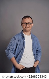 Portrait of man with down syndrome on gray background - Shutterstock ID 2268303343