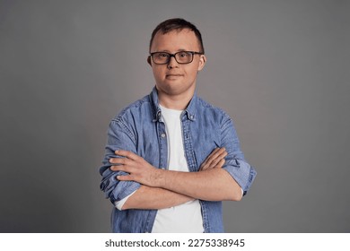 Portrait of man with down syndrome on gray background - Shutterstock ID 2275338945
