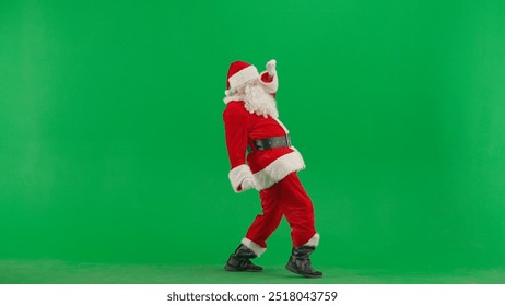 Portrait of man dressed as Santa on chroma key green screen background. Santa Claus in red suit dancing funny. Side view. - Powered by Shutterstock