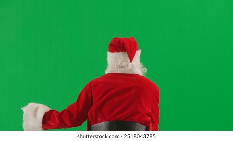 Portrait of man dressed as Santa on chroma key green screen background. Santa Claus in red outfit walking and greeting people around, waving. Back view. - Powered by Shutterstock