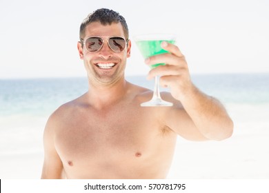 Portrait Of Man Drinking Cocktail On The Beach