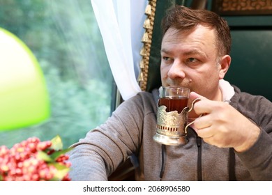 Portrait Of Man Drinking Tea In Train Compartment