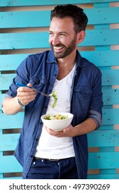 Portrait Of Man Eating Healthy Food And Smiling