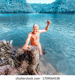 Portrait Of A Man Emerging From The Water On The Coast Of The Reservoir.