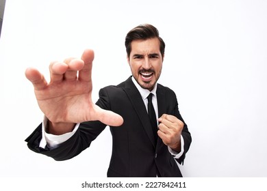 Portrait of a man in an expensive business suit close-up wide-angle lens pulling his hands into the camera with his mouth open screams against a white background, copy location - Powered by Shutterstock