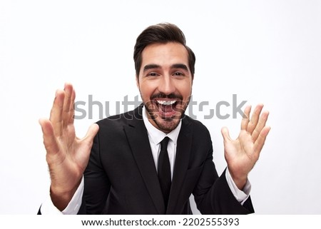 Portrait of a man in an expensive business suit close-up wide-angle lens pulls his hands into the camera with open mouth surprise happiness smile with teeth on a white background, copy space