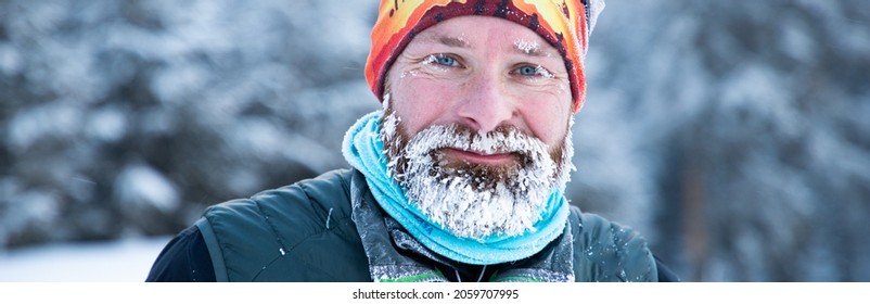 Portrait Of Man Face With Frozen Beard In Harsh Winter