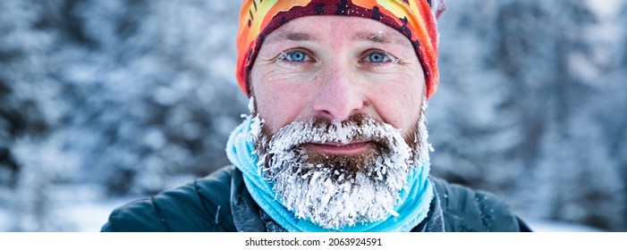 Portrait Of Man Face With Frozen Beard In Harsh Winter