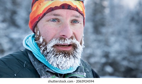 Portrait Of Man Face With Frozen Beard In Harsh Winter