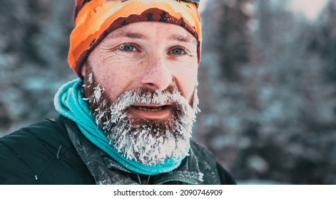 Portrait Of Man Face With Frozen Beard In Harsh Winter