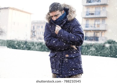 Portrait of man feeling very cold and shivering in winter