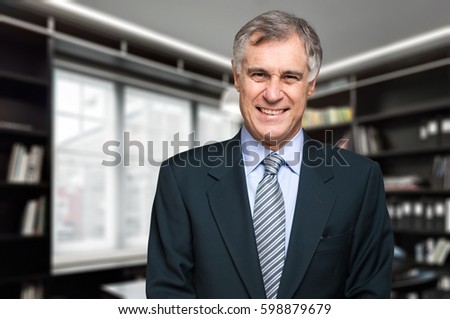 Portrait of a man in front of a book