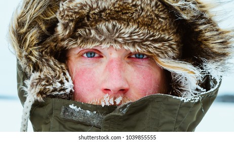 Portrait of man with frozen face outdoors in rural canada during snowshoeing