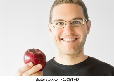 Portrait of a man with glasses holding an apple