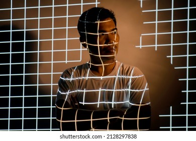 Portrait Of A Man With Grid Abstract Light. Unusual, Interesting And Fantastic Photoshoot. Isolated In Studio Light
