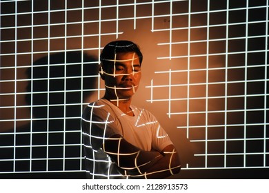 Portrait Of A Man With Grid Abstract Light. Unusual, Interesting And Fantastic Photoshoot. Isolated In Studio Light
