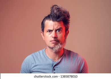 A Portrait Of Man With Half Beard And Hair On Brown Background