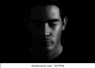 Portrait Of A Man With Half Face On Shadow