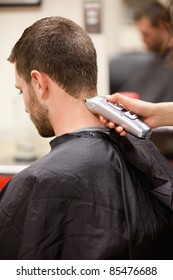 Portrait Of Man Having A Haircut With A Hair Clippers
