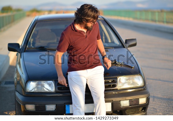 portrait of man with his car\
and gun