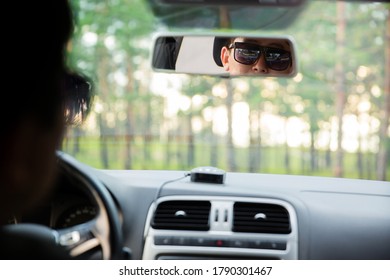 Portrait Of A Man In His Car Looking In The Rearview Mirror