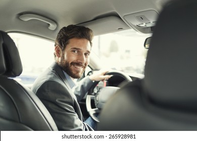 Portrait Of Man In His Car. Looking Camera